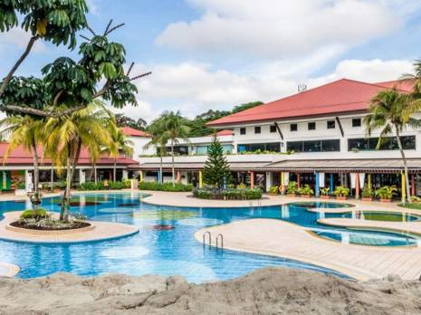 view of a hotel with a swimming pool