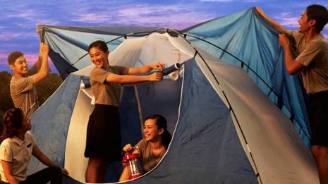 teenagers pitching tent